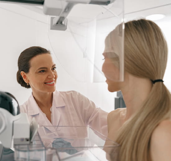 Doctor preforming a mammogram.