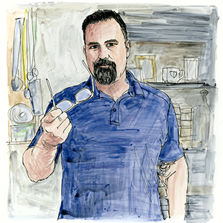 A man holding his glasses and staring straight ahead.