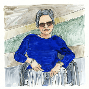 Laurie sits in her wheelchair outside.