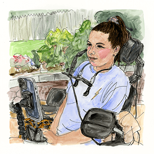 Victoria sits in a wheelchair in a garden.