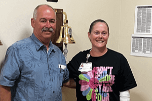 Don Gutshall with Aleecia Munchel photographed in front of the Hope Bell at UPMC Community Osteopathic in Harrisburg.