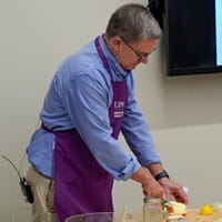 Dr. Michael Bosak showing participants how to prepare the apple harvest salad with kale.