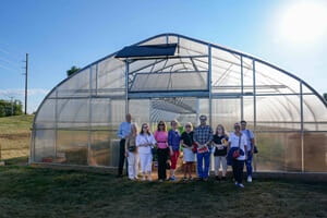 Several participants of the “Cooking with a Cardiologist” event pictured in front of the UPMC Memorial Farm's temperature-controlled high tunnels.
