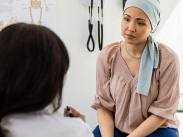 Female cancer patient talking with her doctor