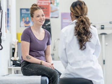 Patient in exam room with doctor