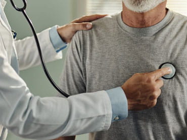 Doctor listens to patient's heart