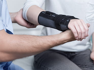 Orthopaedic doctor examining wrist 