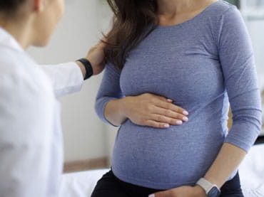 Pregnant woman talking with doctor