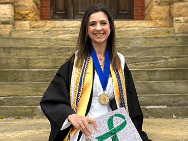 Image of Taylor in her graduation cap and gown.